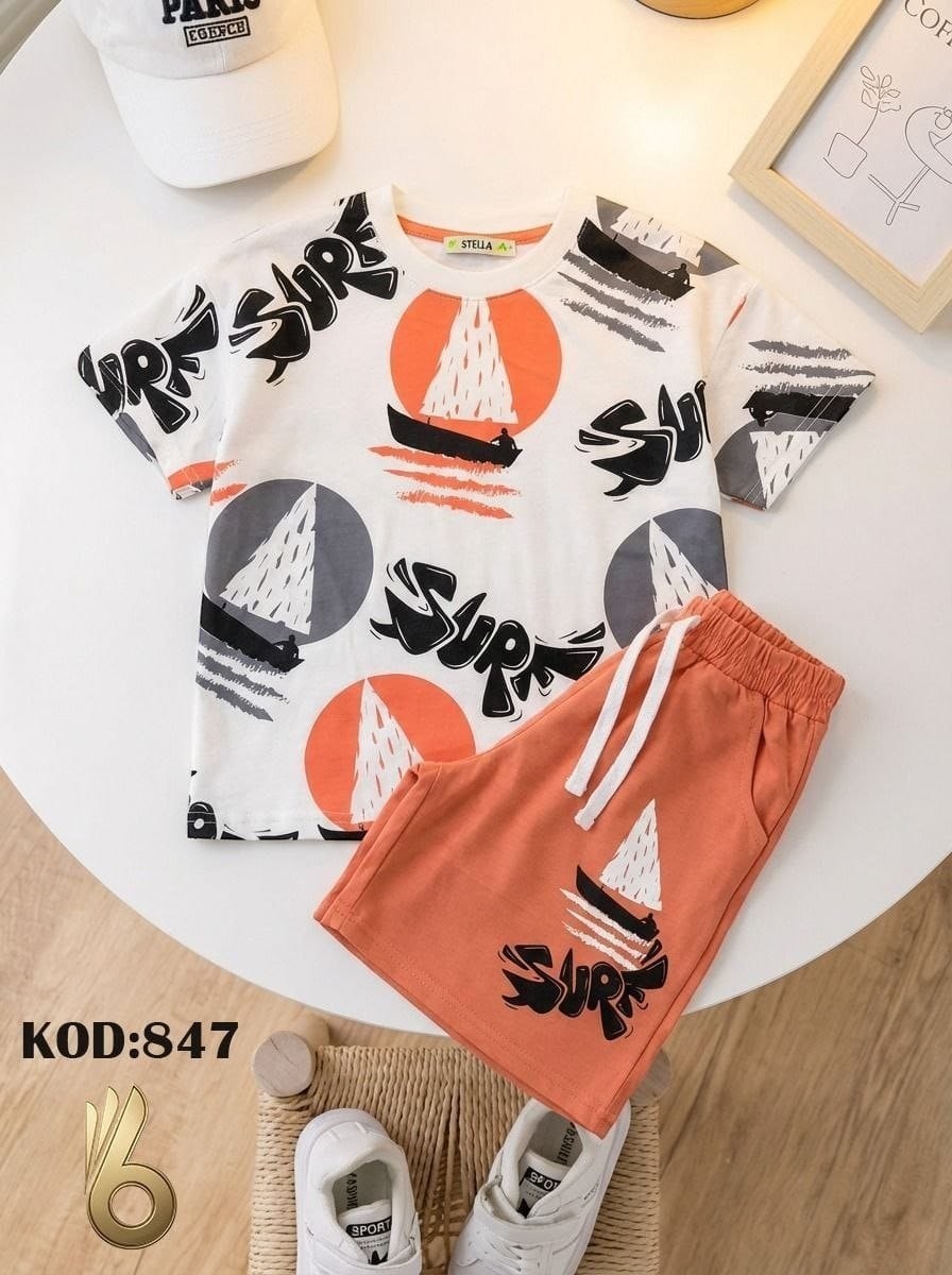 The Nile Luxuries white cotton t-shirt and orange shorts set with sailboat graphic and "SURF" print. Elastic waistband shorts.