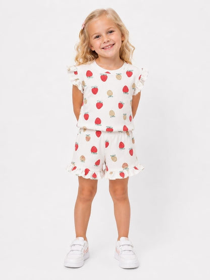 The Nile Luxuries girls' white ribbed lounge set with strawberry print, flutter sleeves, and ruffled shorts.