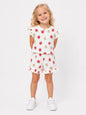 The Nile Luxuries girls' white ribbed lounge set with strawberry print, flutter sleeves, and ruffled shorts.