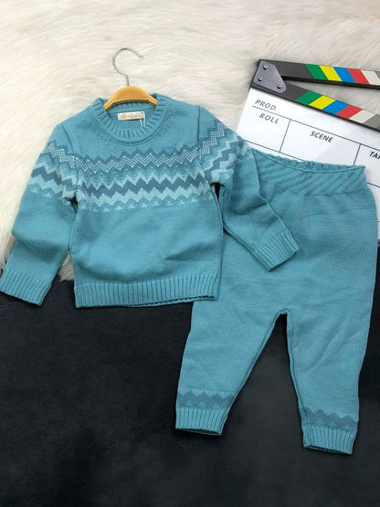 The Nile Luxuries teal knitted sweater and pant set featuring a chevron pattern on the chest and ribbed cuffs.