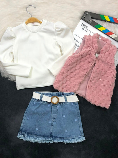 The Nile Luxuries three-piece outfit with a white ribbed top, pink faux-fur vest, and heart-embroidered denim skirt.