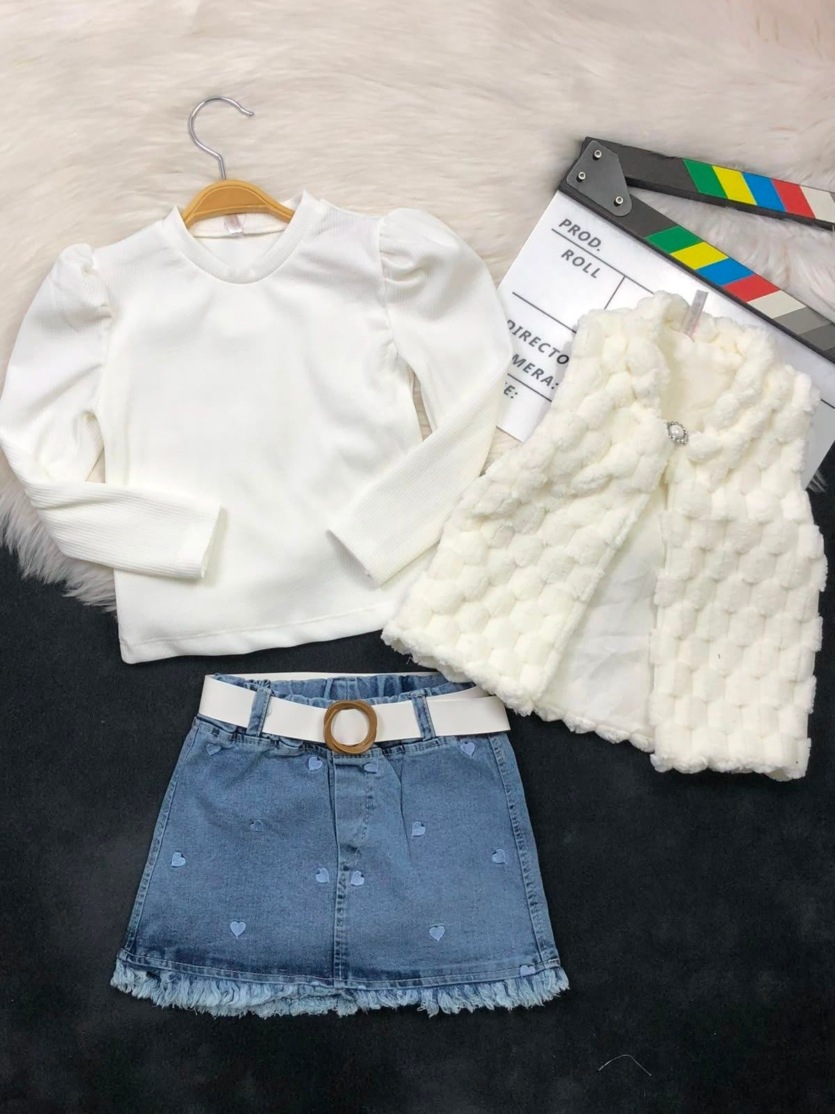 The Nile Luxuries three-piece outfit with white ribbed puff-sleeve top, faux-fur vest, and heart-embroidered denim skirt