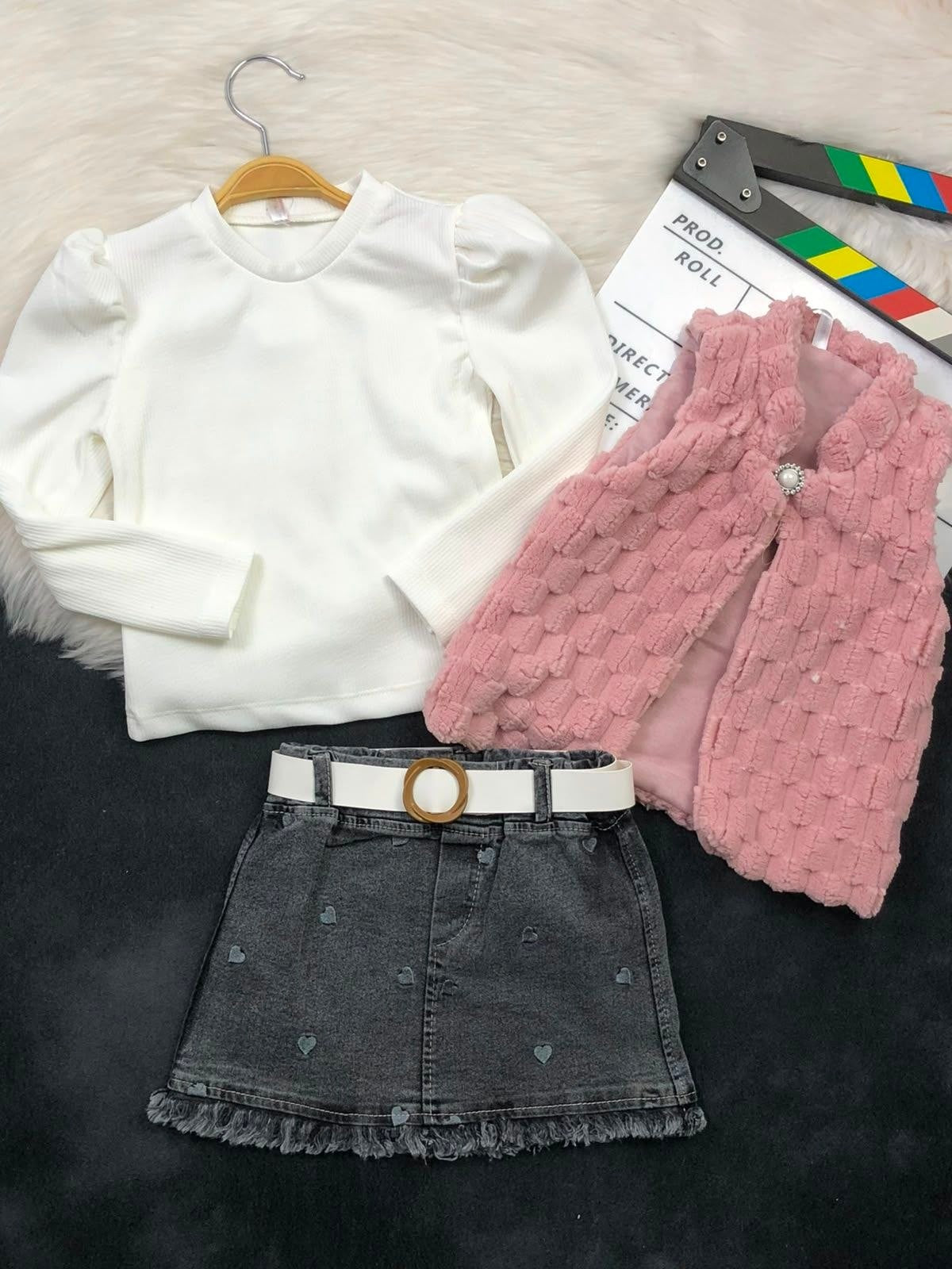 The Nile Luxuries three-piece set with white ribbed top, pink faux-fur vest, and heart-embroidered denim skirt.