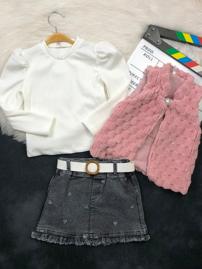 The Nile Luxuries three-piece set with white ribbed top, pink faux-fur vest, and heart-embroidered denim skirt.