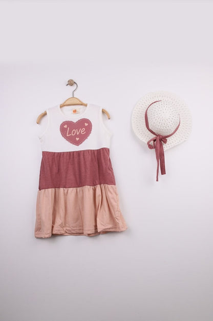 The Nile Luxuries tiered sleeveless dress in white, rose, and blush pink with a heart graphic that says "Love".
