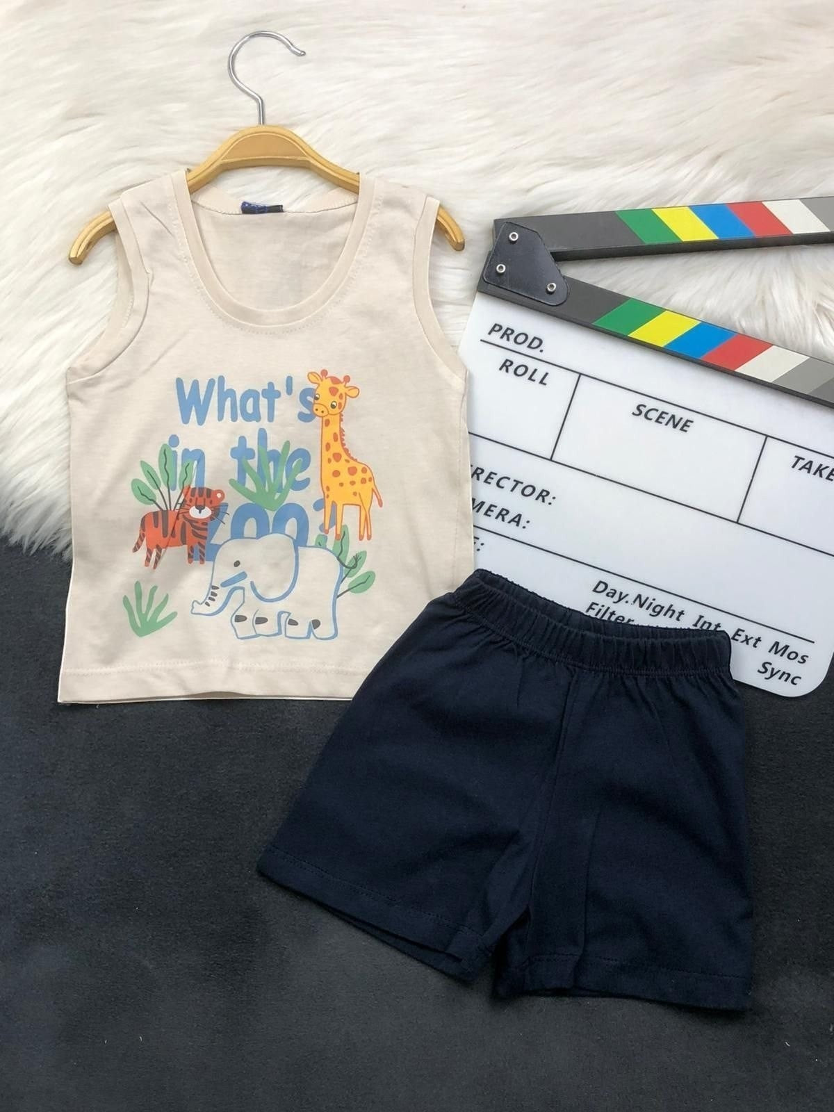The Nile Luxuries toddler two-piece set with a beige animal graphic tank top and navy blue pull-on shorts.
