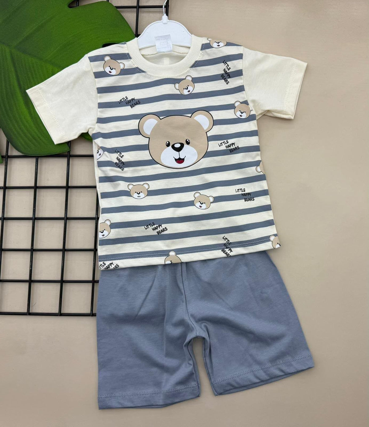 The Nile Luxuries toddler two-piece set featuring a cream striped bear graphic t-shirt and solid blue pull-on shorts.