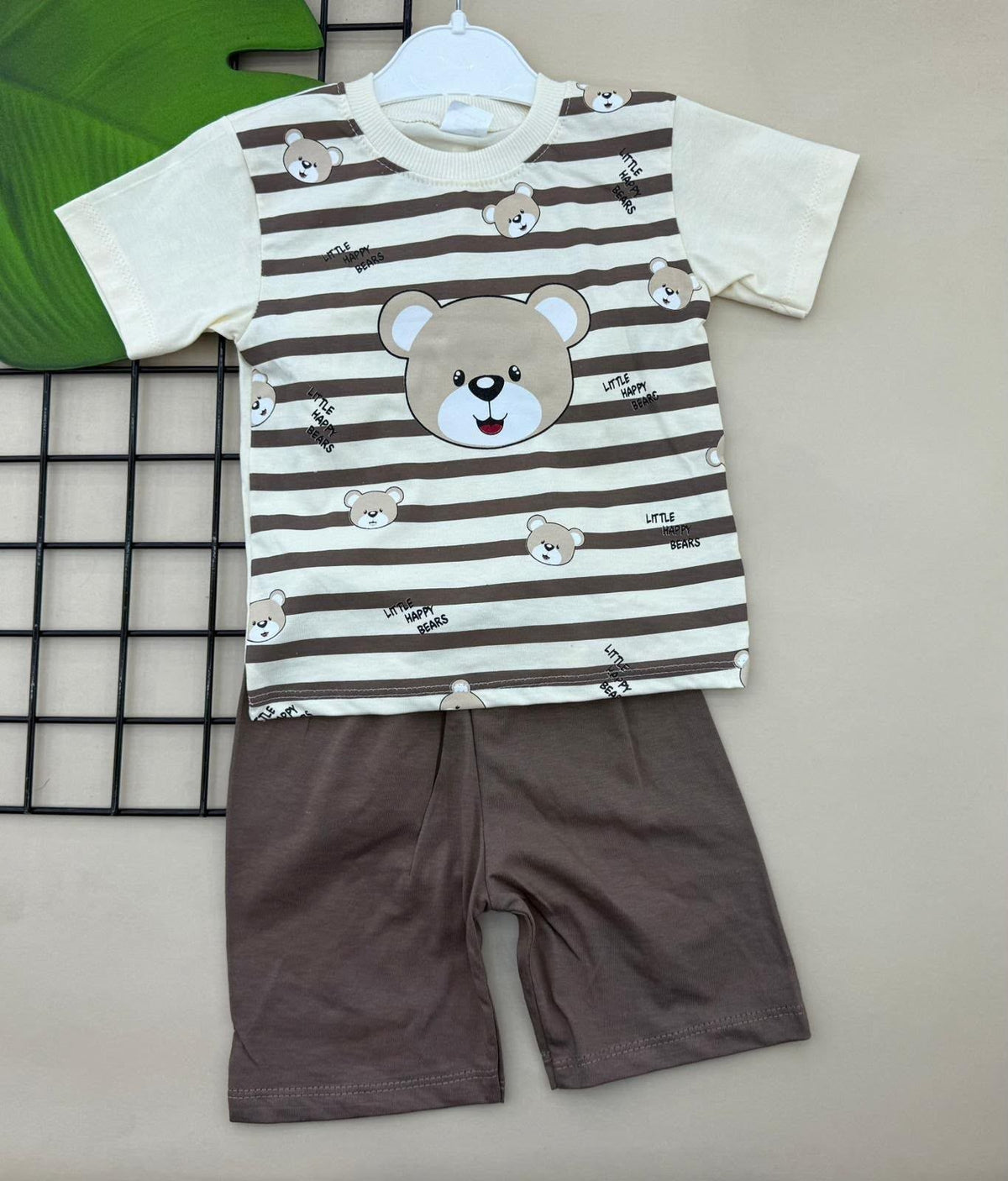 The Nile Luxuries toddler pajama set with a striped bear graphic t-shirt and solid brown shorts in soft cotton fabric.