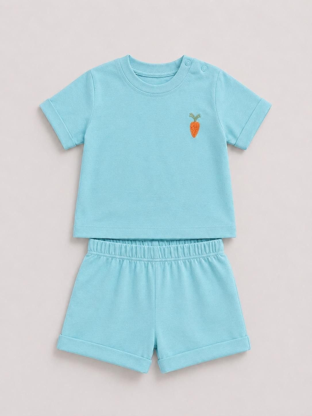 The Nile Luxuries light blue toddler short sleeve shirt and shorts set with a small embroidered carrot on the chest.