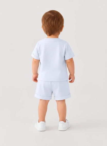 Toddler wearing The Nile Luxuries light blue short sleeve shirt and matching cuffed shorts from behind