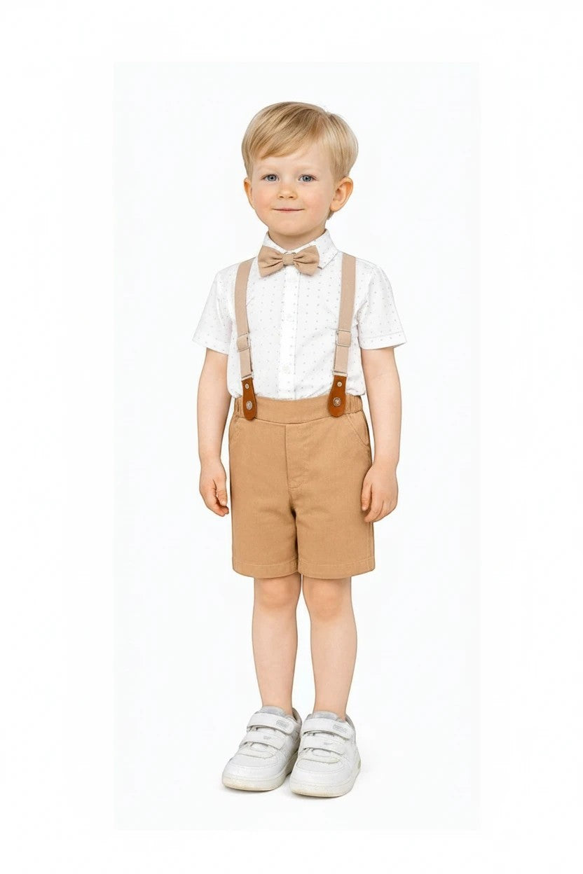 Toddler boy wearing The Nile Luxuries formal white patterned shirt, tan shorts, bow tie, and adjustable suspenders.