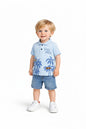 Toddler boy wearing The Nile Luxuries light blue tropical polo shirt with palm trees and denim shorts on white background