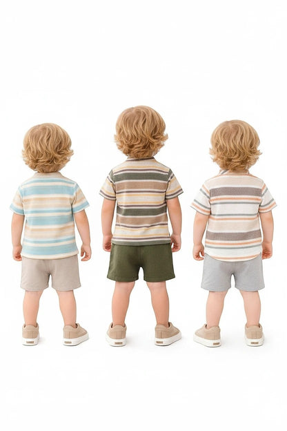 Three toddlers wearing The Nile Luxuries striped henley shirts and solid shorts in earthy summer colors.