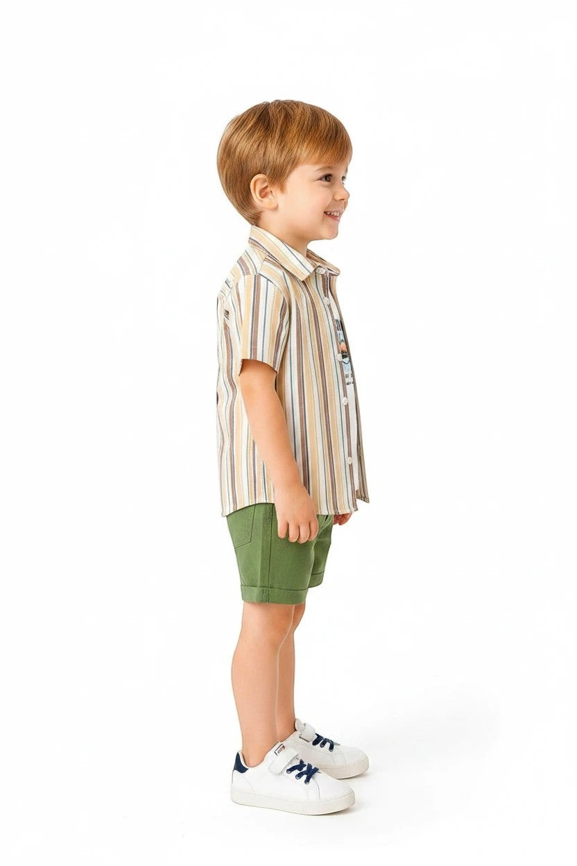 Toddler boy wearing The Nile Luxuries striped button-down shirt, graphic tee, and green shorts on a white background.