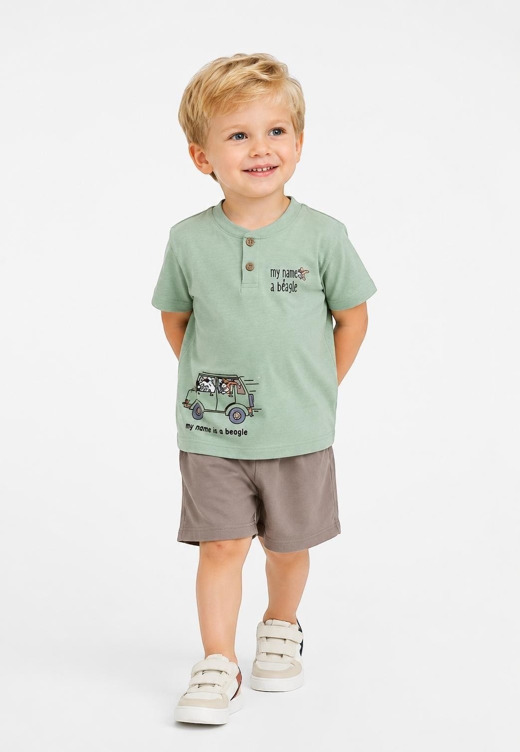 Toddler boy wearing a sage green The Nile Luxuries henley t-shirt with beagle graphic and brown shorts
