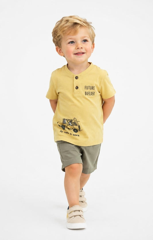 Toddler boy wearing a mustard yellow The Nile Luxuries henley t-shirt with Future Builder graphic and olive shorts.