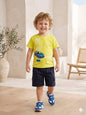 The Nile Luxuries toddler boy wearing a yellow graphic t-shirt with a sports car print and navy blue cargo shorts.