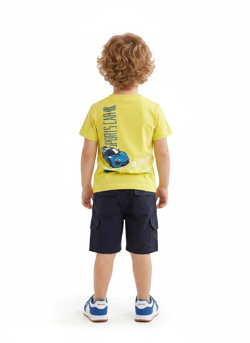 The Nile Luxuries toddler boy wearing a yellow sports car graphic t-shirt and navy blue cargo shorts from behind.