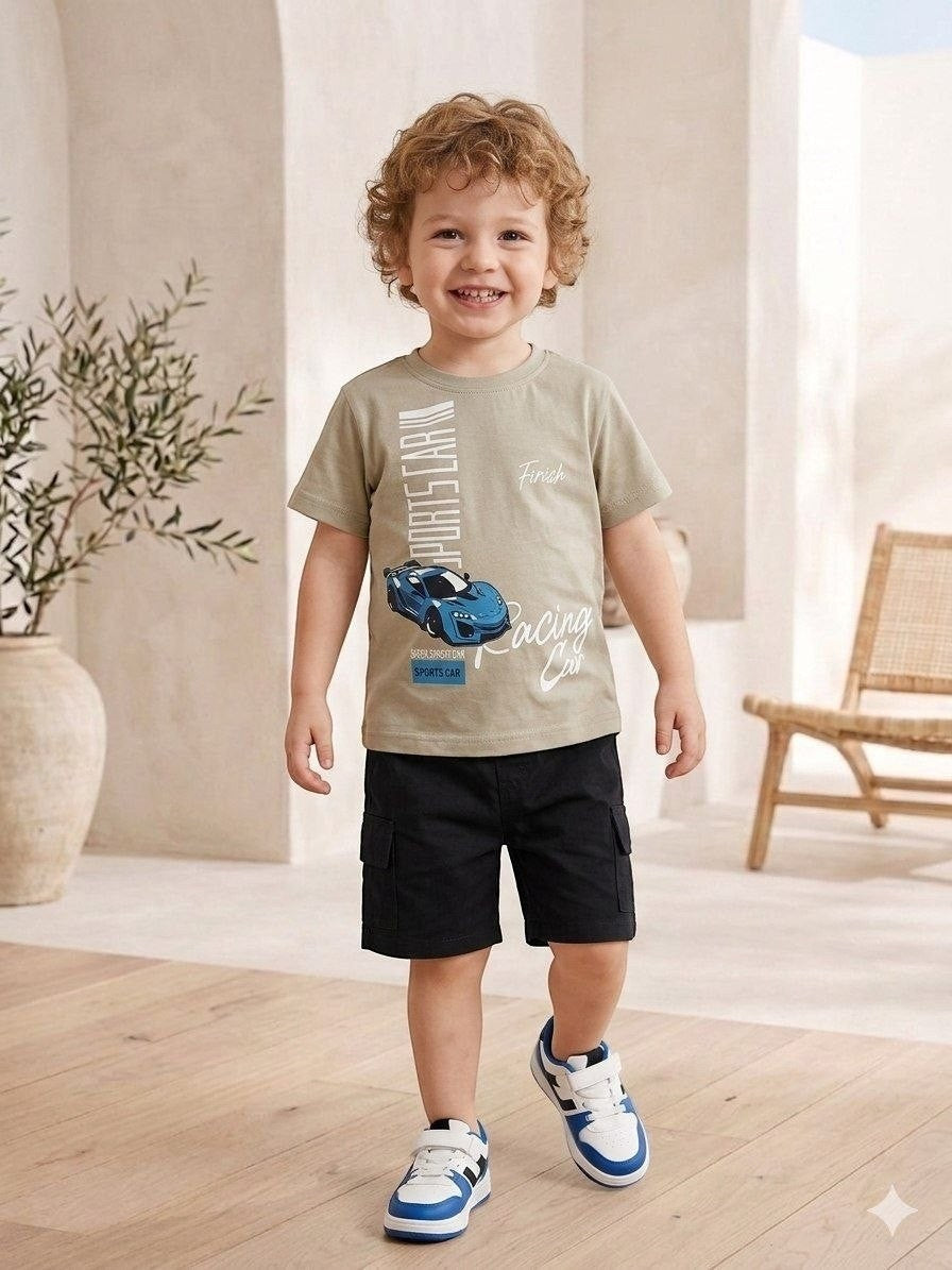 The Nile Luxuries toddler boy wearing a sage green sports car graphic t-shirt and black cargo shorts with sneakers.
