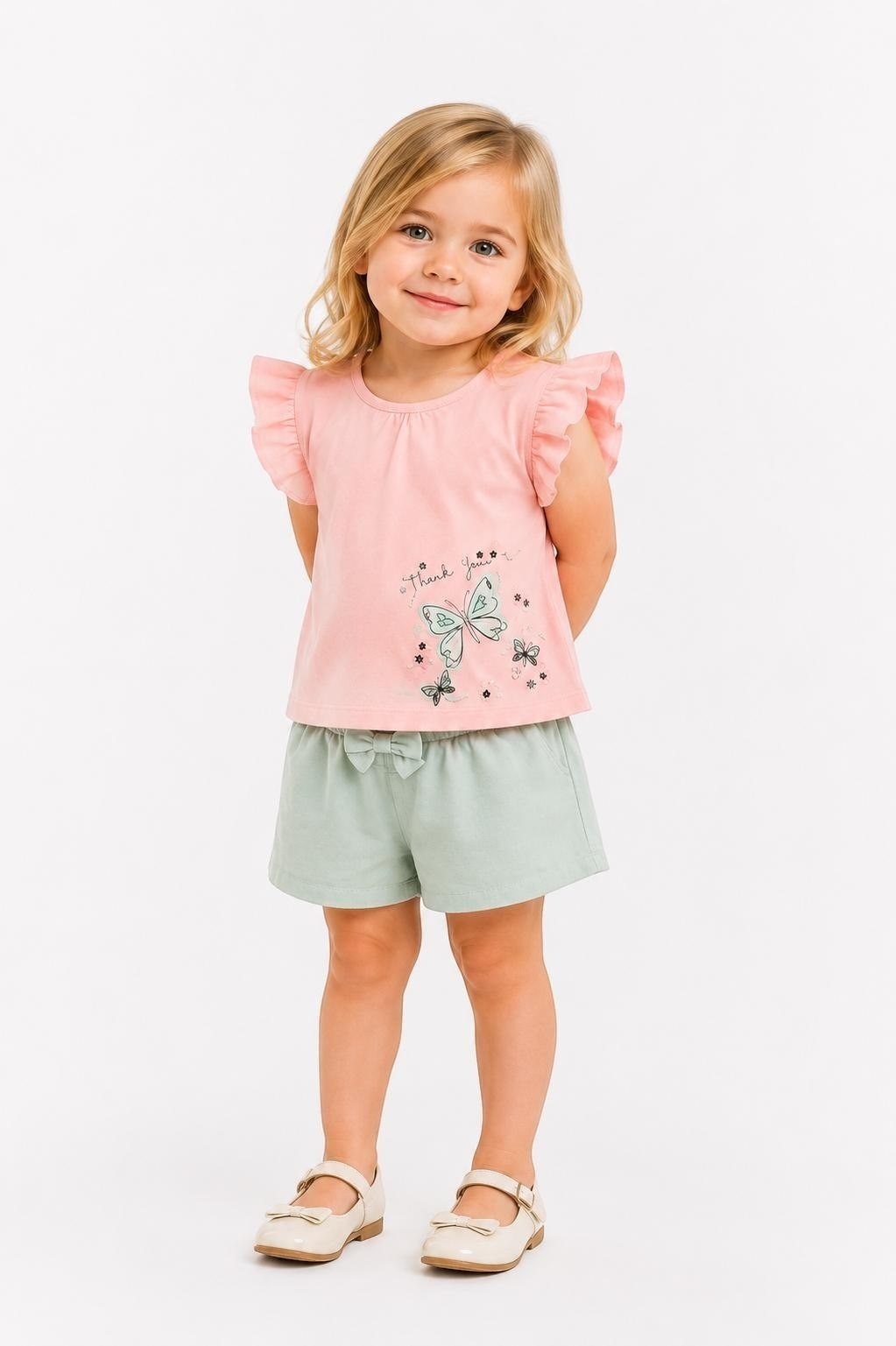 Toddler girl wearing The Nile Luxuries pink flutter sleeve butterfly top and sage green bow shorts set.