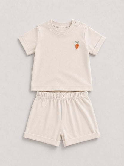 The Nile Luxuries toddler beige short sleeve shirt and shorts set with a cute embroidered carrot on the chest.