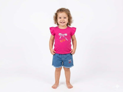 Toddler girl wearing The Nile Luxuries pink flutter-sleeve cherry graphic t-shirt and frayed denim shorts set.