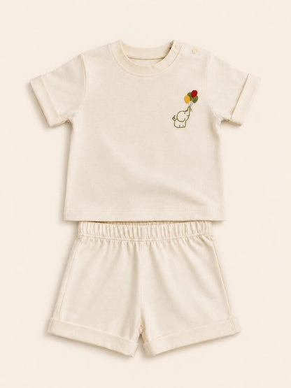 The Nile Luxuries toddler cream short sleeve shirt and shorts set with an embroidered elephant and balloon design.