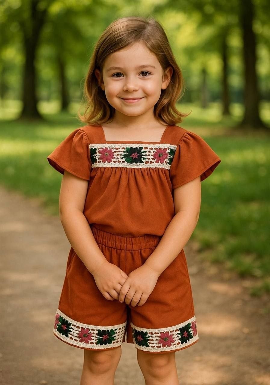 The Nile Luxuries toddler girl rust-colored flutter-sleeve top and shorts set with floral embroidery and lace trim.