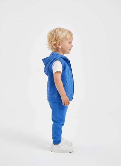 Toddler boy wearing The Nile Luxuries royal blue equestrian hooded vest, white t-shirt, and matching jogger pants.