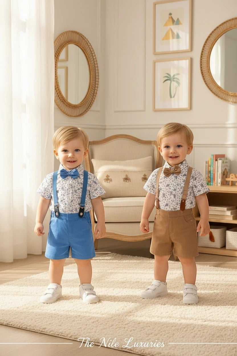 Two toddlers wearing The Nile Luxuries formal floral shirt sets with suspenders, bow ties, and shorts in blue and tan.