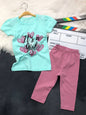 The Nile Luxuries toddler girl outfit set with a mint green graphic t-shirt and dusty pink leggings.