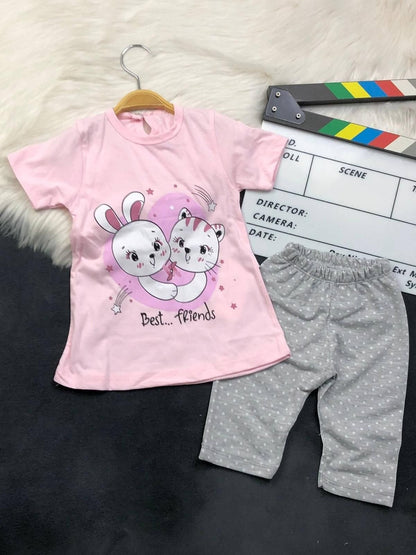 The Nile Luxuries toddler lounge set with a pink Best Friends graphic t-shirt and grey polka-dot cropped leggings.