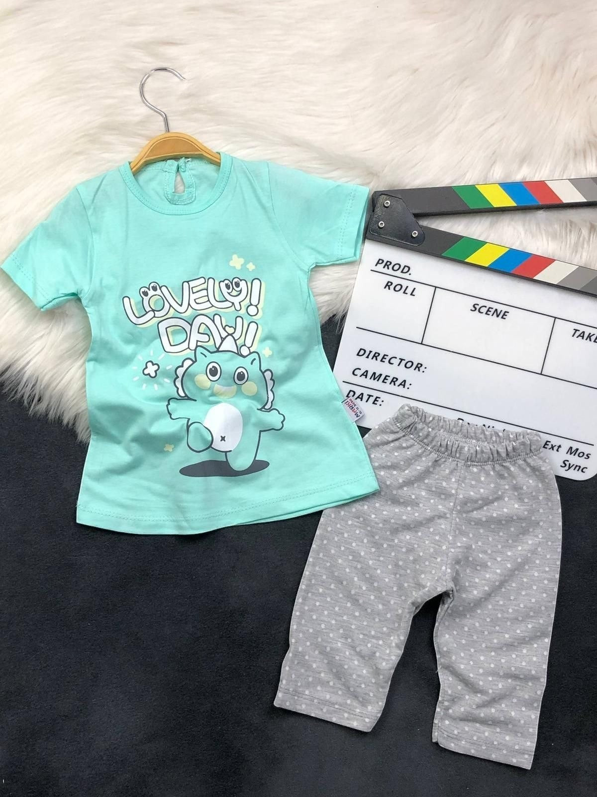 The Nile Luxuries toddler outfit with mint green Lovely Day graphic t-shirt and grey polka dot leggings.