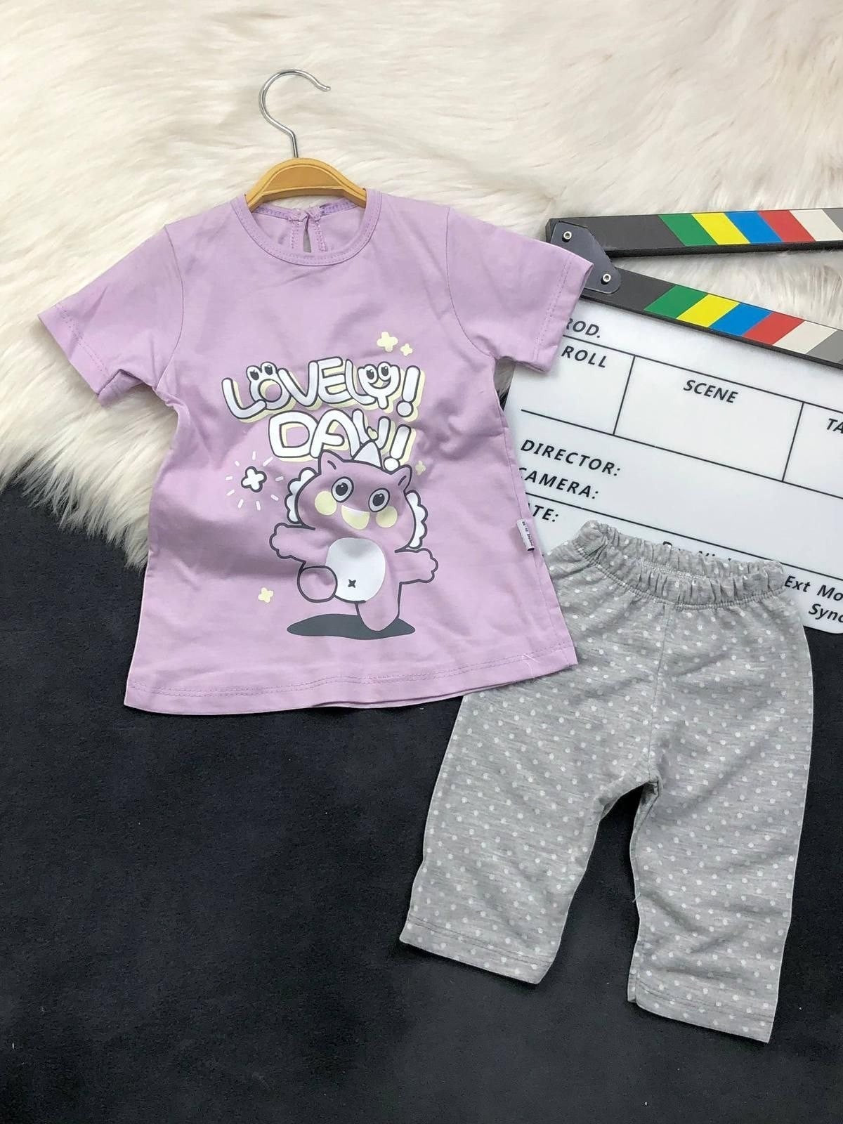 The Nile Luxuries toddler outfit with a purple Lovely Day graphic t-shirt and grey polka-dot leggings.