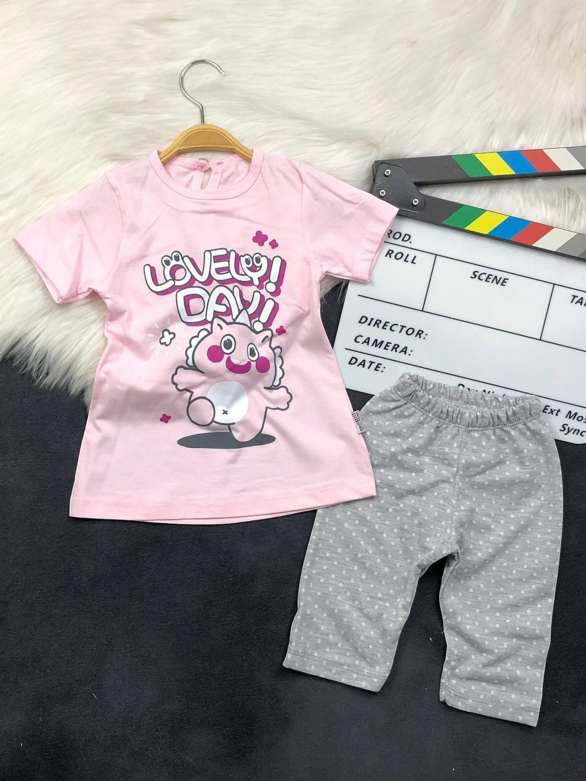 The Nile Luxuries toddler outfit with a pink Lovely Day graphic t-shirt and grey polka-dot leggings.