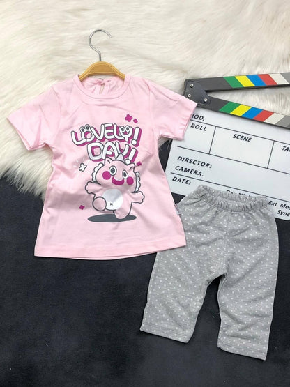The Nile Luxuries toddler outfit with a pink Lovely Day graphic t-shirt and grey polka-dot leggings.