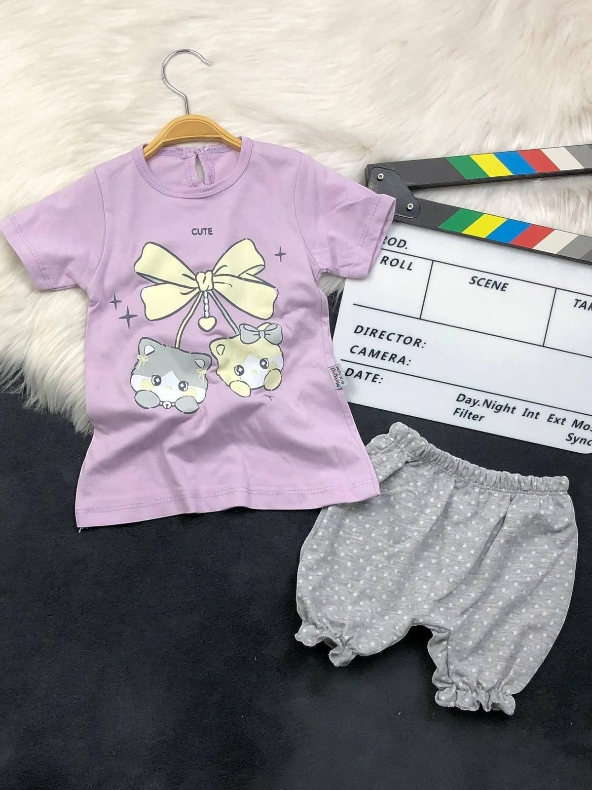 The Nile Luxuries toddler outfit with a lavender kitten graphic t-shirt and grey polka-dot ruffled bloomers.