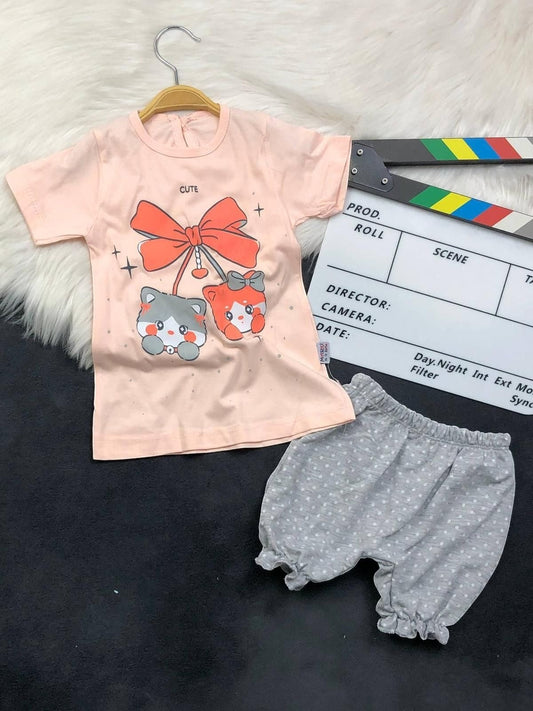 The Nile Luxuries toddler set with a peach kitten graphic t-shirt and grey polka-dot ruffled bloomers.