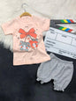The Nile Luxuries toddler set with a peach kitten graphic t-shirt and grey polka-dot ruffled bloomers.