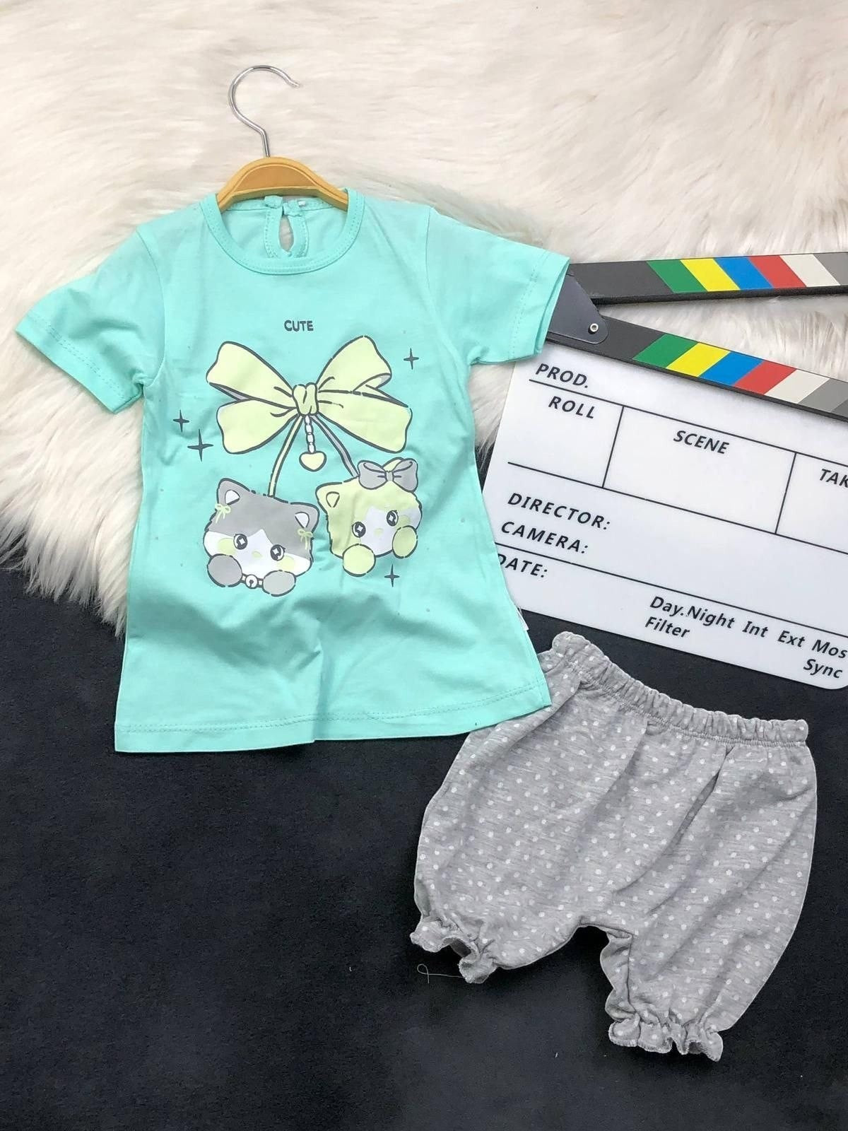 The Nile Luxuries toddler set with mint green kitten graphic t-shirt and grey polka-dot ruffled bloomers.
