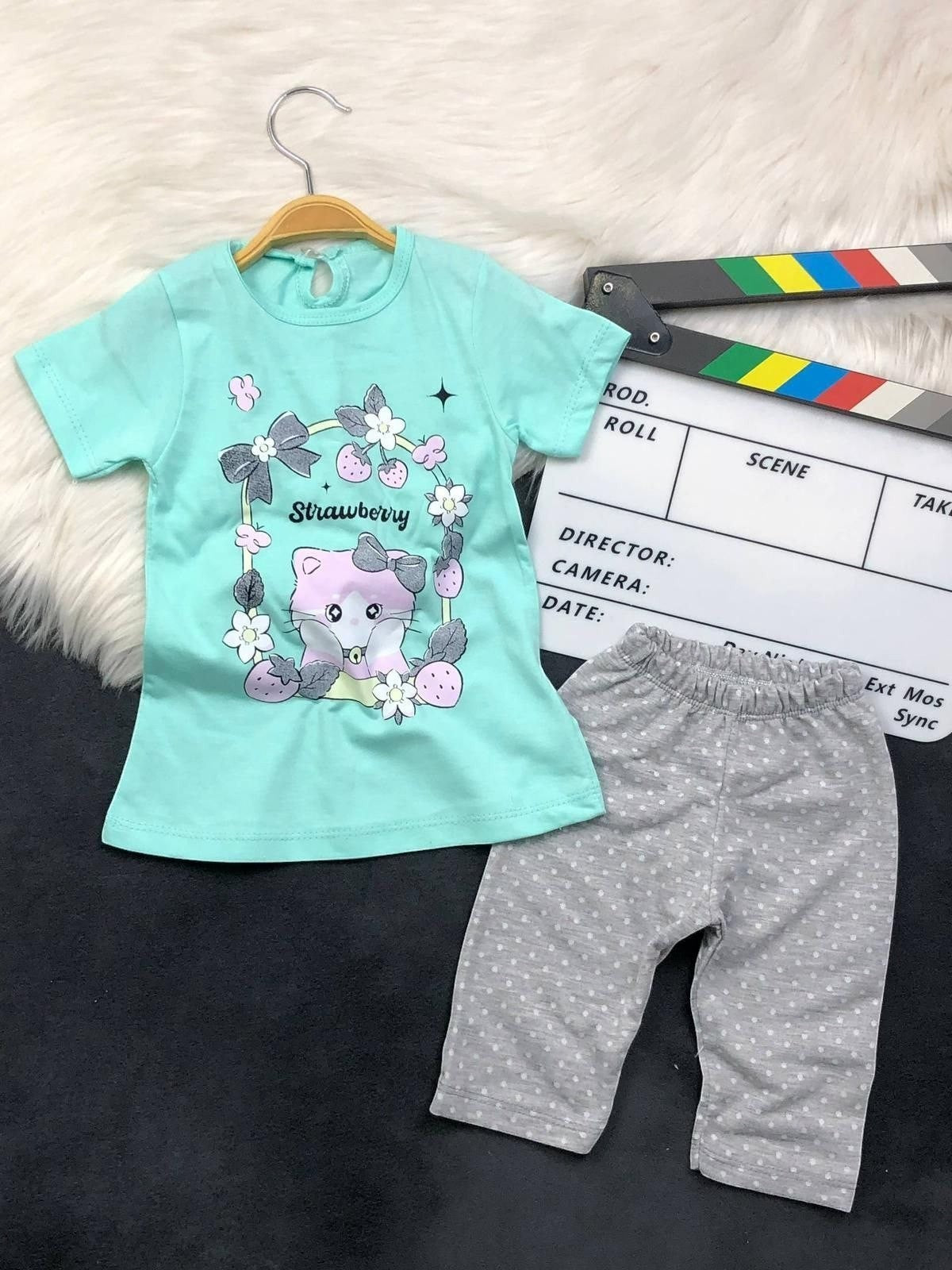 The Nile Luxuries toddler set with a mint green kitten graphic t-shirt and grey polka dot pants.