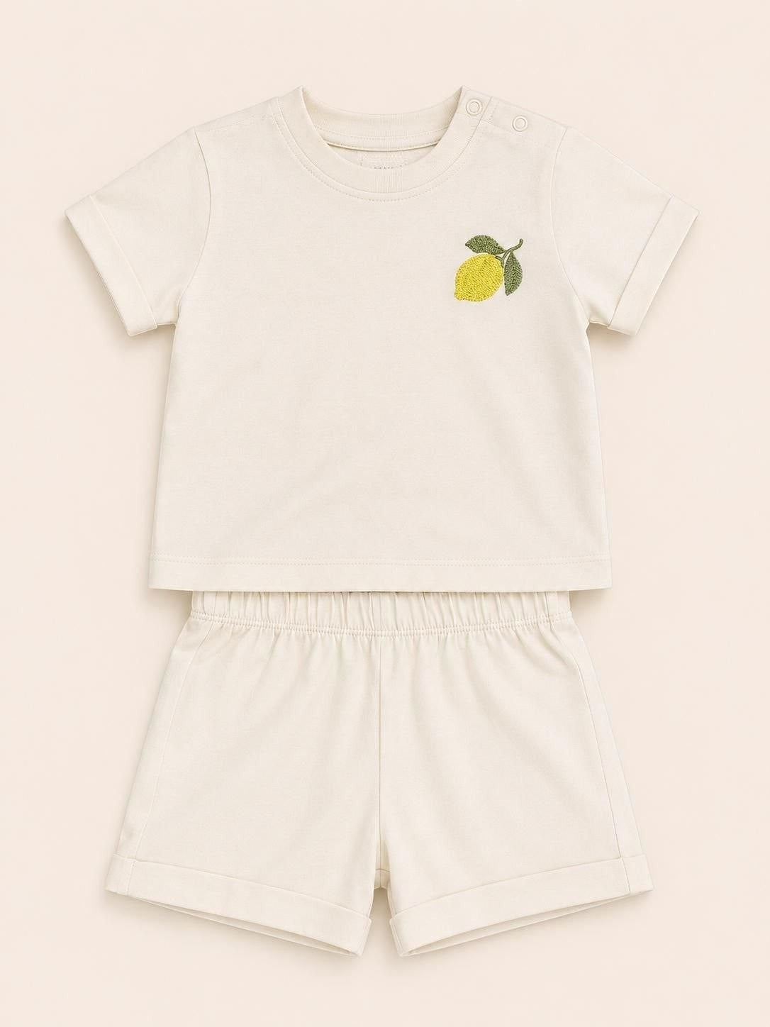 The Nile Luxuries toddler cream short sleeve shirt and shorts set with a lemon embroidery on the chest