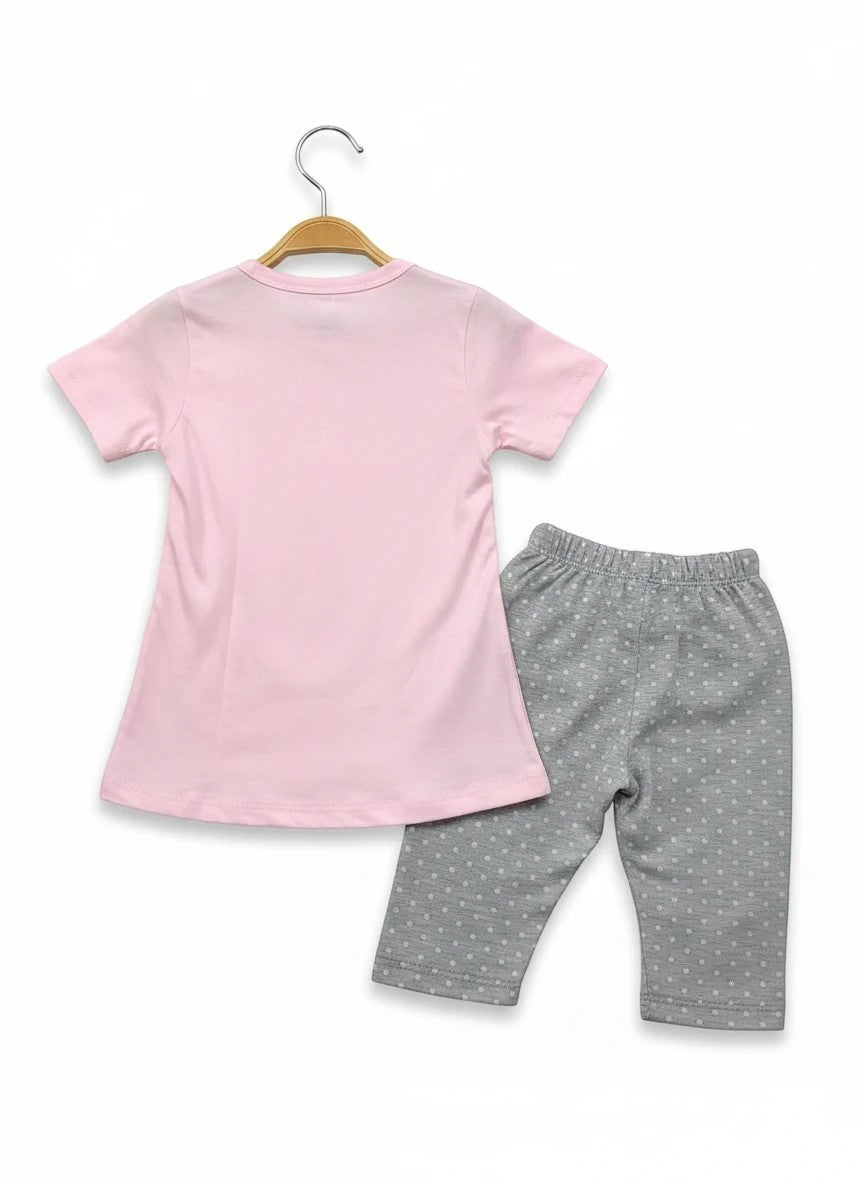 The Nile Luxuries toddler lounge set with a plain pink short-sleeve t-shirt and grey polka-dot cropped leggings.