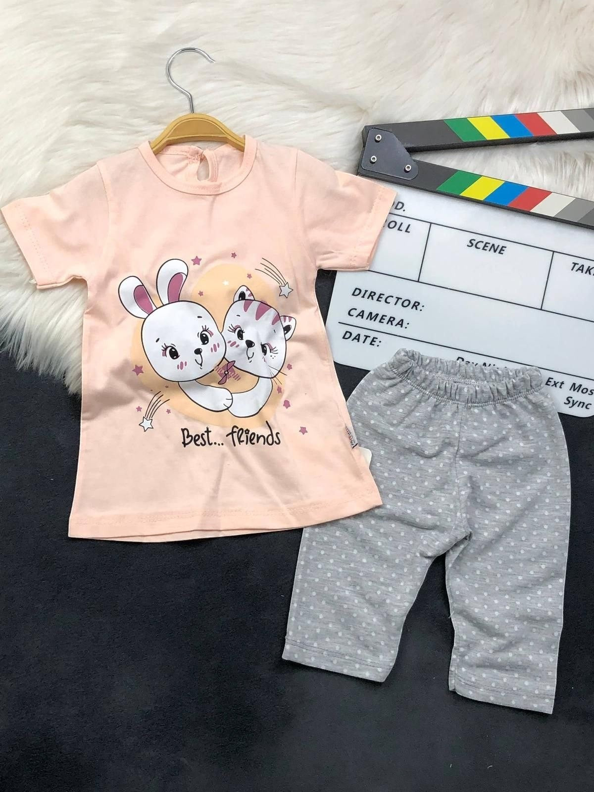 The Nile Luxuries toddler lounge set with a peach graphic t-shirt and grey polka-dot cropped leggings.