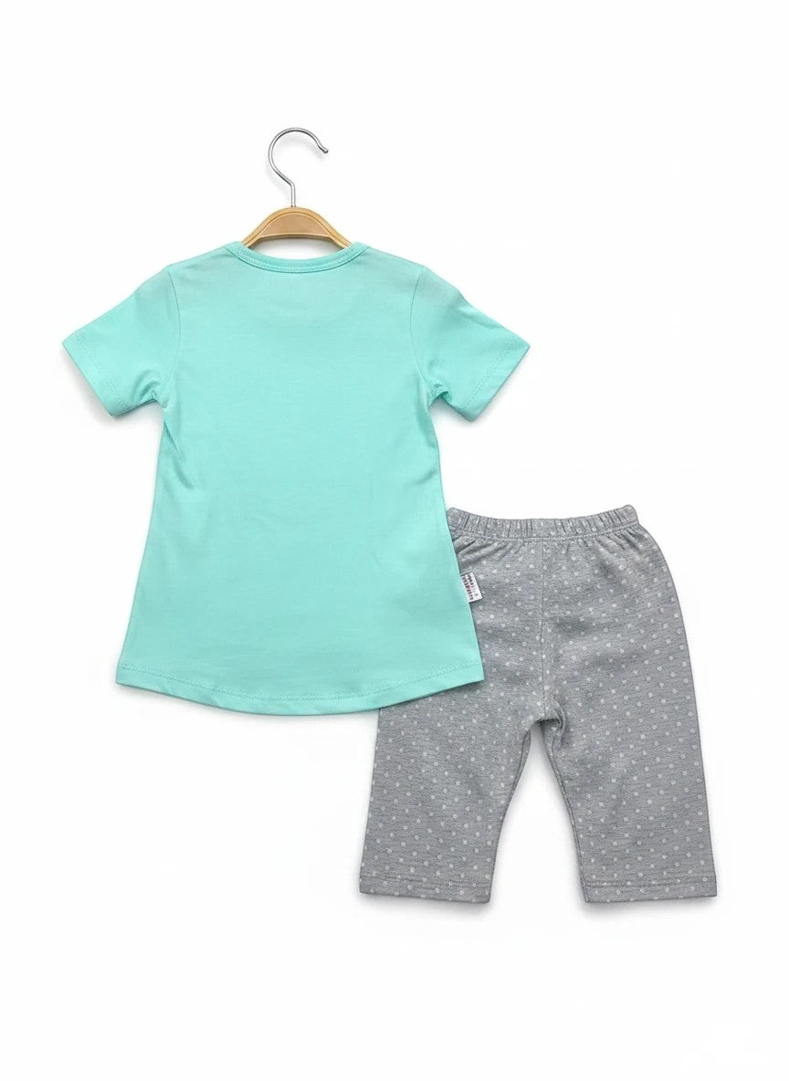 The Nile Luxuries toddler outfit set with a mint green short-sleeve t-shirt and grey polka-dot leggings.