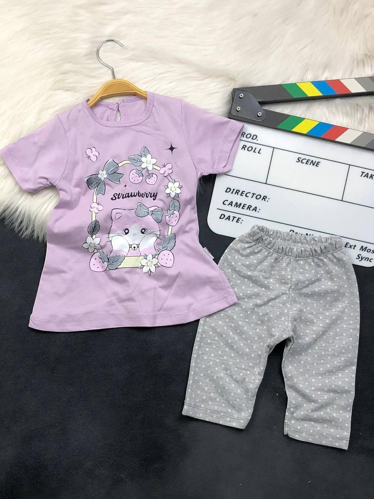 The Nile Luxuries toddler pajama set with a lavender kitten graphic t-shirt and grey polka dot pants.