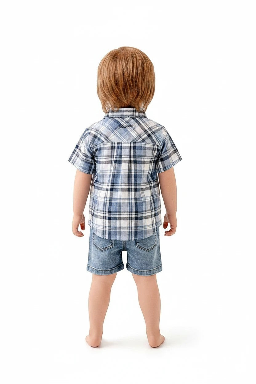Toddler boy wearing a The Nile Luxuries blue plaid short-sleeve button-down shirt and denim shorts, back view.