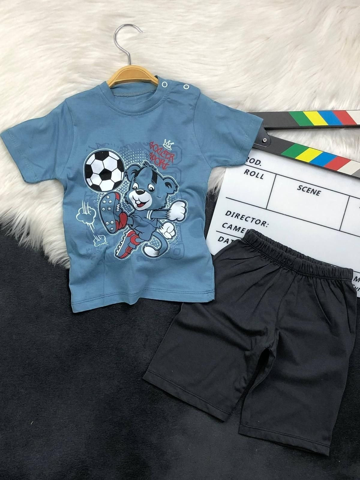 The Nile Luxuries toddler boys blue soccer bear graphic t-shirt and black shorts set with shoulder snap buttons.