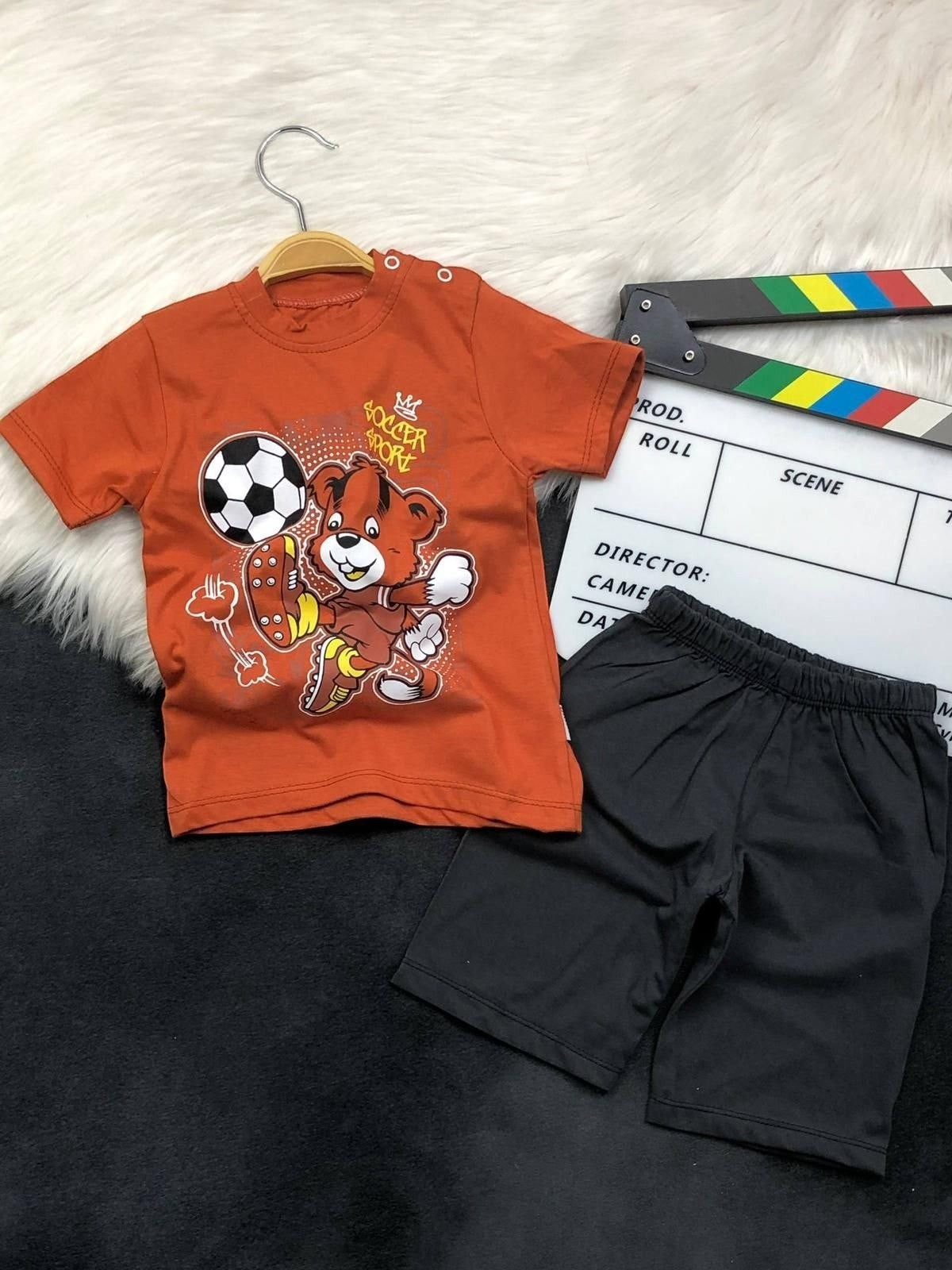 The Nile Luxuries toddler boys soccer bear graphic t-shirt and black shorts set with shoulder snaps.