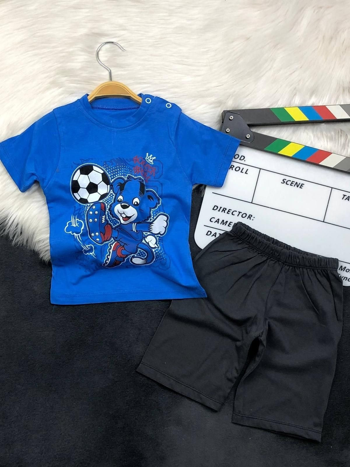 The Nile Luxuries toddler boys blue soccer bear graphic t-shirt and black shorts set with shoulder snap buttons.